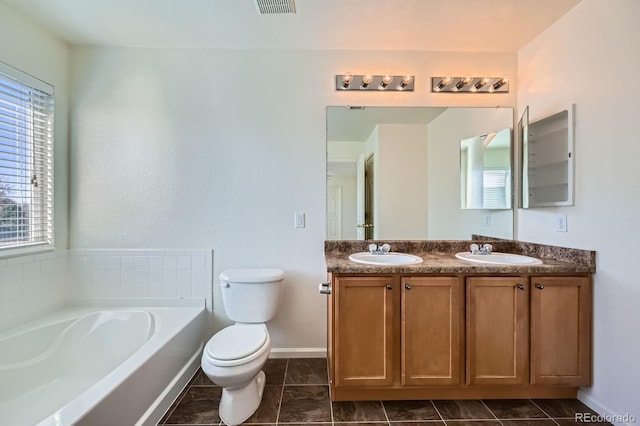 full bath with double vanity, toilet, a garden tub, and a sink