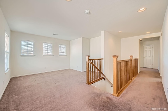 empty room with baseboards, recessed lighting, visible vents, and light carpet