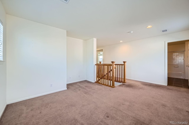 empty room featuring carpet flooring, recessed lighting, visible vents, and baseboards