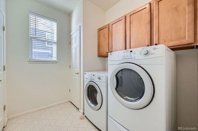 laundry room with cabinet space, washer and dryer, baseboards, and light floors