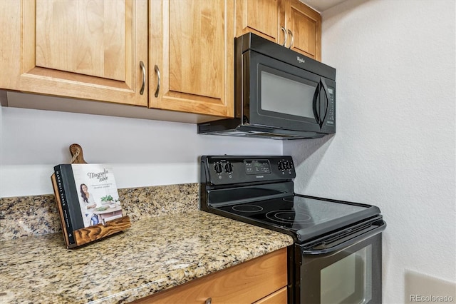 kitchen featuring light stone countertops and black appliances