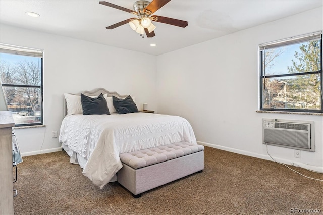 carpeted bedroom with an AC wall unit and ceiling fan