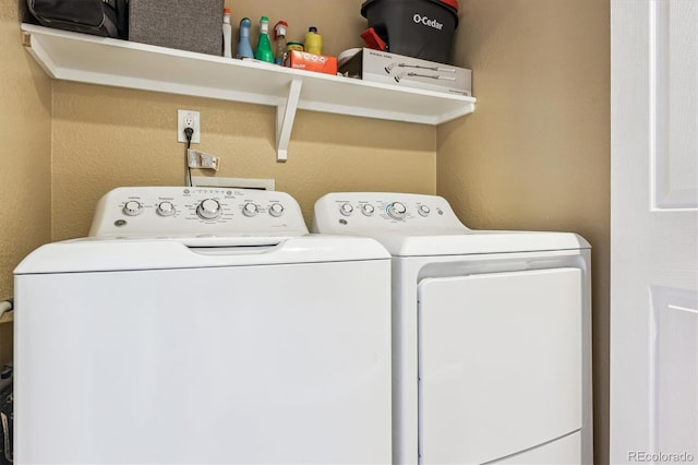 clothes washing area featuring separate washer and dryer