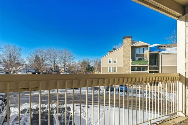 view of snow covered back of property