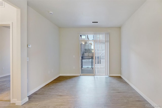 spare room with light wood-type flooring