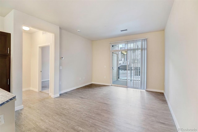 spare room with light wood-type flooring