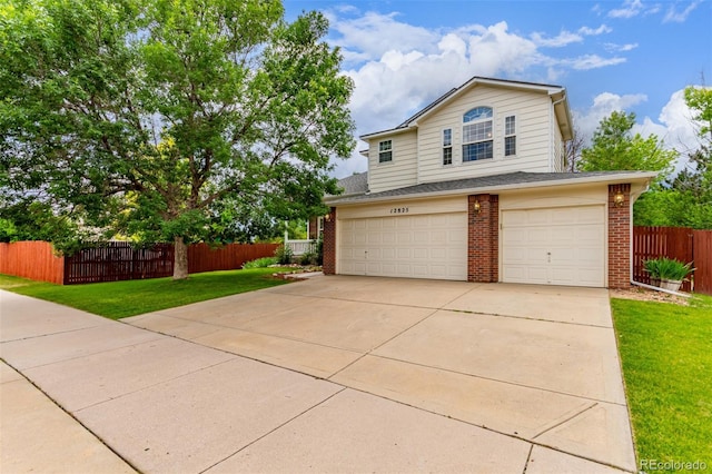 12825 Forest Way, Thornton, CO 80241 - view of front of property with brick siding, an attached garage, and driveway