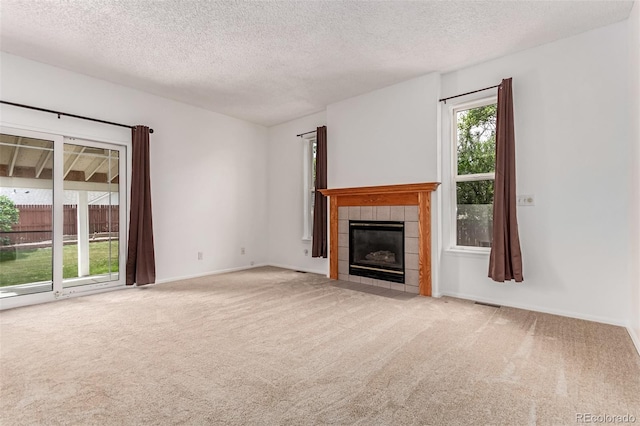 12825 Forest Way, Thornton, CO 80241 - unfurnished living room featuring carpet, a fireplace, and a textured ceiling