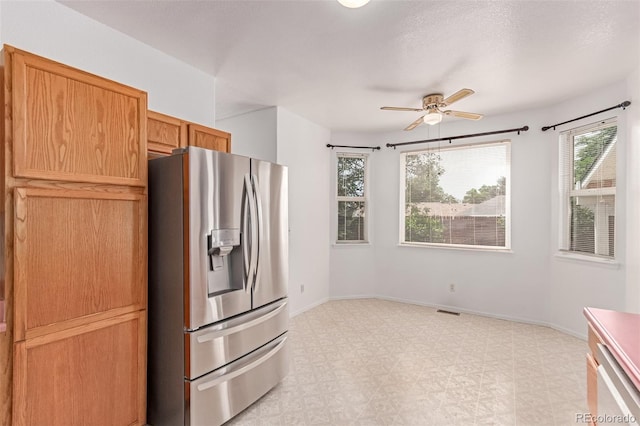 12825 Forest Way, Thornton, CO 80241 - kitchen featuring stainless steel fridge, light floors, and ceiling fan