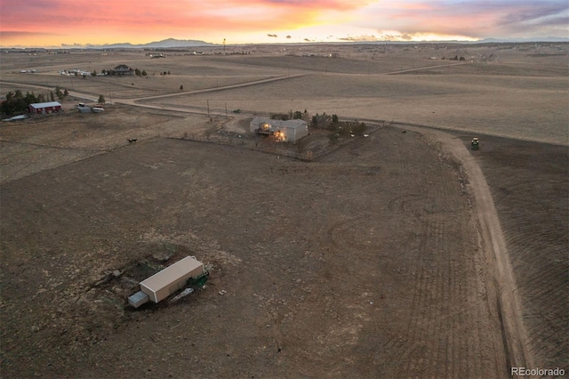 birds eye view of property with a mountain view and a rural view