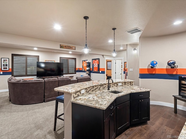2028 Lost Canyon Ranch Ct, Castle Rock, CO 80104 - kitchen featuring a sink, dark cabinetry, baseboards, and visible vents