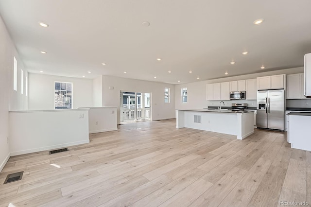 kitchen featuring open floor plan, visible vents, and stainless steel appliances