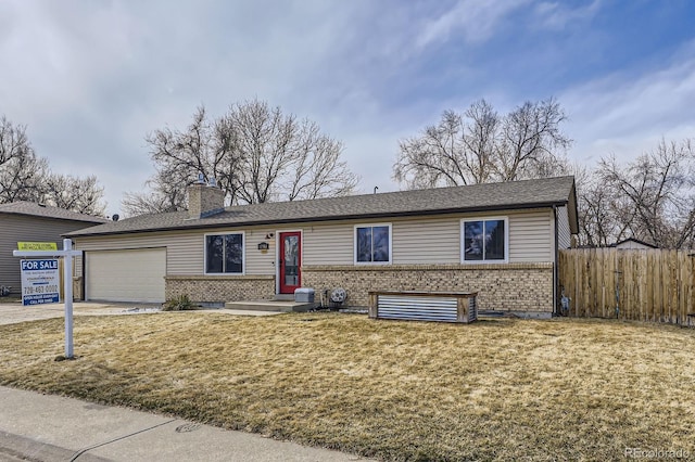 ranch-style house with brick siding, fence, concrete driveway, a front lawn, and a chimney