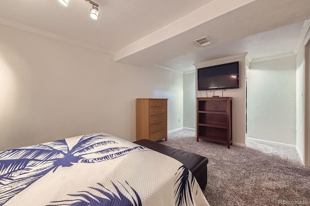 bedroom featuring carpet floors, crown molding, visible vents, a textured wall, and baseboards