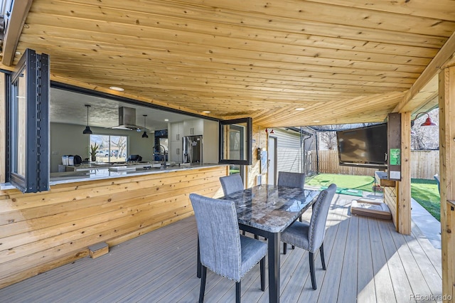 deck featuring outdoor dining area and a sink