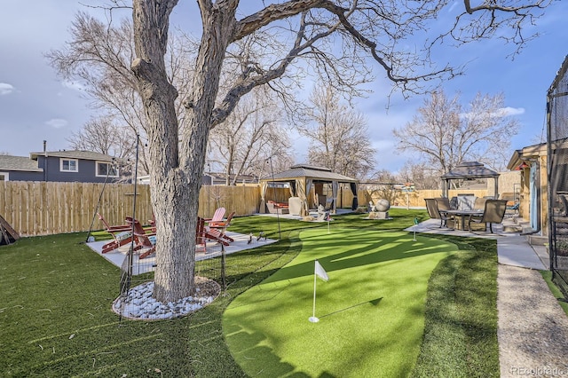 view of yard with a gazebo, a patio area, and a fenced backyard