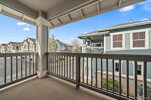 balcony featuring central AC unit and a residential view
