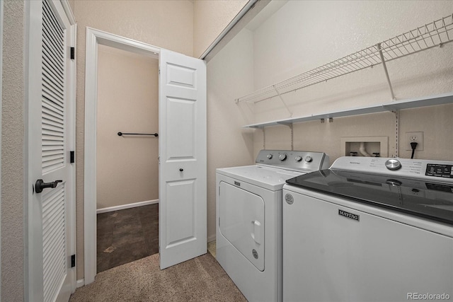 laundry area with washing machine and dryer, baseboards, and laundry area