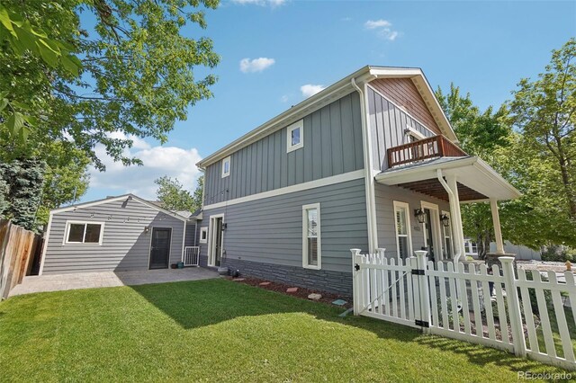 4603 W 33rd Ave, Denver, CO 80212 - back of house with board and batten siding, a balcony, a gate, and a patio area