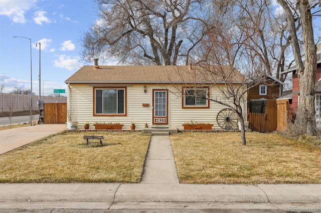 ranch-style home with a front lawn