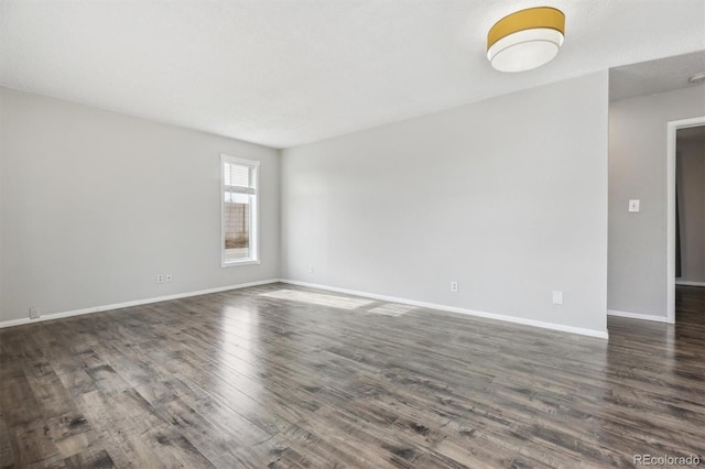 empty room with dark hardwood / wood-style floors