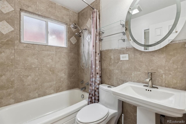 full bathroom with sink, shower / bath combo, tile walls, decorative backsplash, and toilet