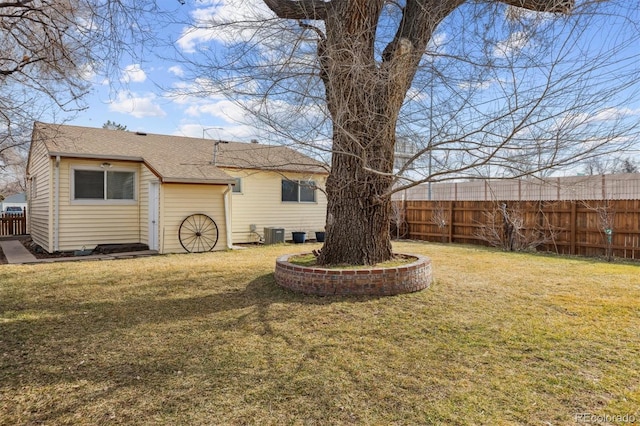 back of property featuring cooling unit and a lawn