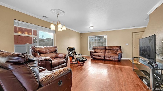 living room with ornamental molding, a healthy amount of sunlight, and wood-type flooring