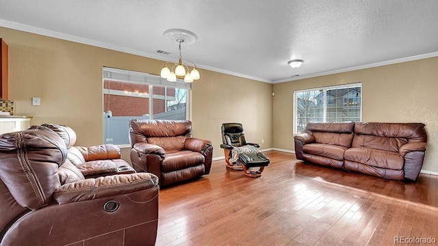 living room with hardwood / wood-style floors, a notable chandelier, and a wealth of natural light