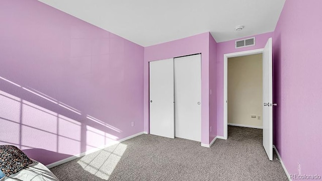 unfurnished bedroom featuring a closet and carpet