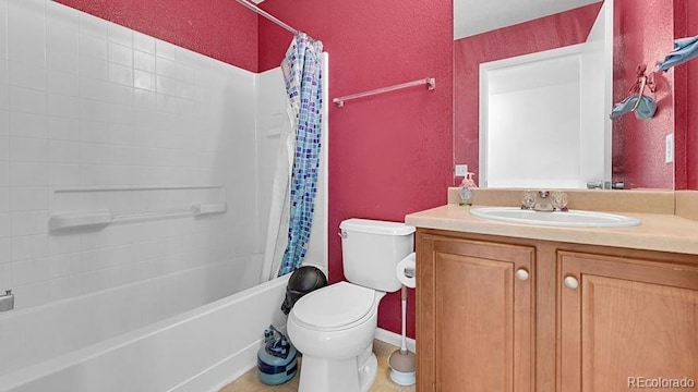 full bathroom featuring vanity, shower / bathtub combination with curtain, and toilet