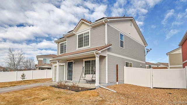 view of front of property with a garage and a patio area