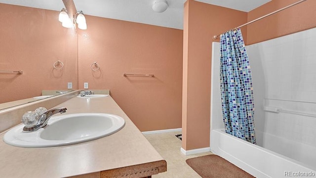 bathroom with shower / tub combo with curtain and vanity