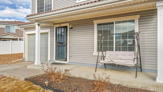 view of exterior entry with a garage