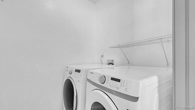 washroom with washer and dryer