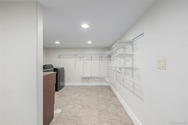 spacious closet with washer and clothes dryer