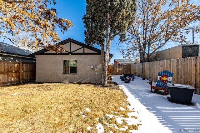 exterior space with a yard, a fenced backyard, and stucco siding