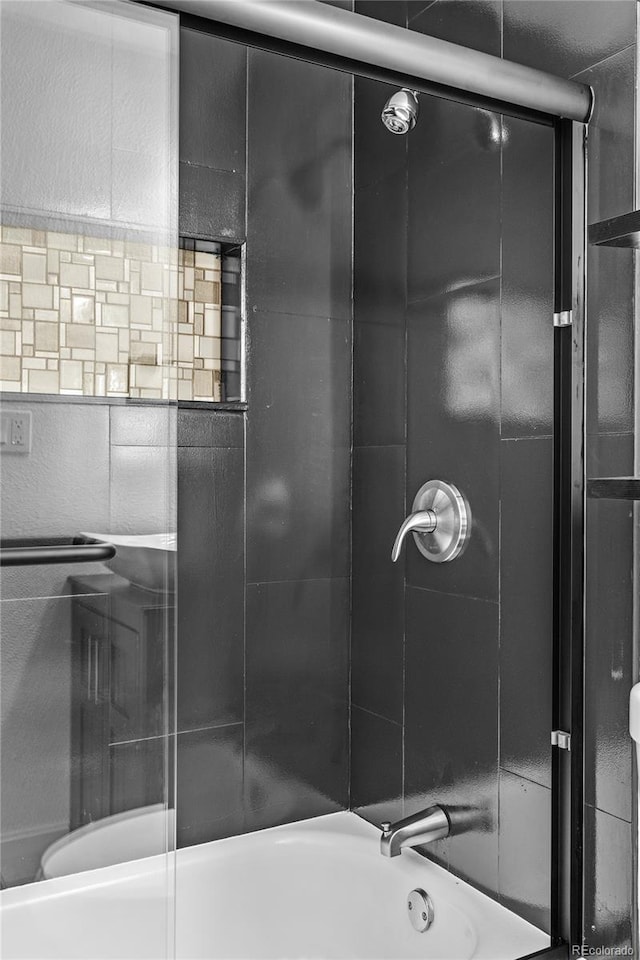 full bathroom featuring bath / shower combo with glass door