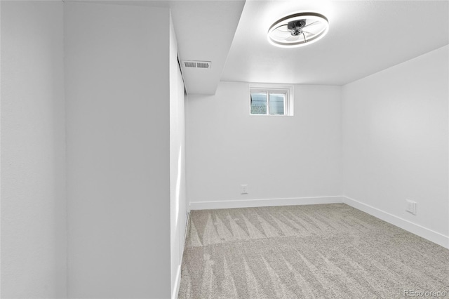 unfurnished room with light colored carpet, visible vents, and baseboards