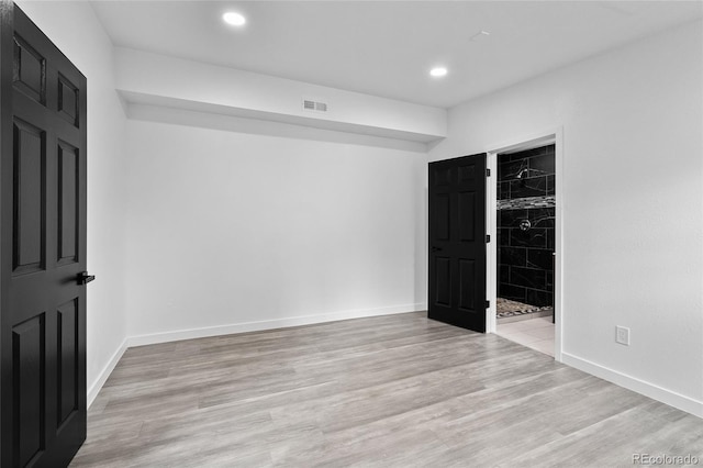 spare room featuring baseboards, recessed lighting, and light wood-style floors