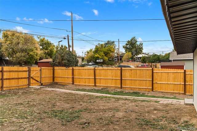 view of yard featuring a fenced backyard and a gate