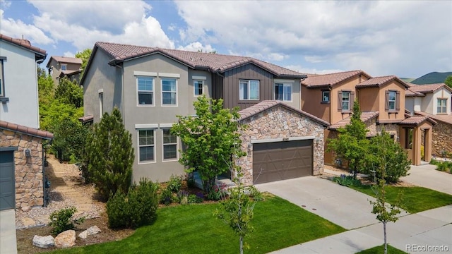 2347 S Loveland St, Lakewood, CO 80228 - view of front facade with driveway, a tile roof, stucco siding, and a residential view