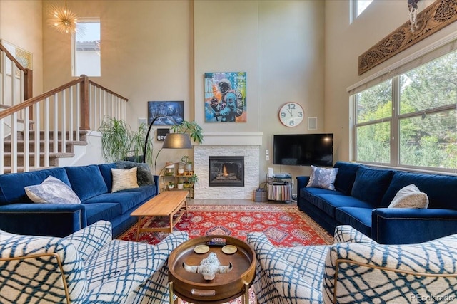 2347 S Loveland St, Lakewood, CO 80228 - living area with a high ceiling, stairs, healthy amount of natural light, and a fireplace