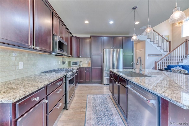 2347 S Loveland St, Lakewood, CO 80228 - kitchen featuring appliances with stainless steel finishes, a sink, light wood-style flooring, recessed lighting, and pendant lighting