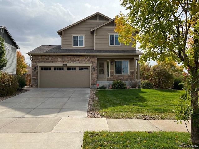 craftsman house with a garage and a front lawn