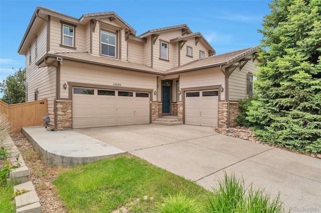 10695 Wynspire Rd, Highlands Ranch, CO 80130 - view of front facade featuring concrete driveway, stone siding, and a garage