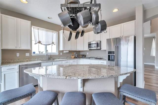 10695 Wynspire Rd, Highlands Ranch, CO 80130 - kitchen featuring appliances with stainless steel finishes, a sink, white cabinetry, and recessed lighting