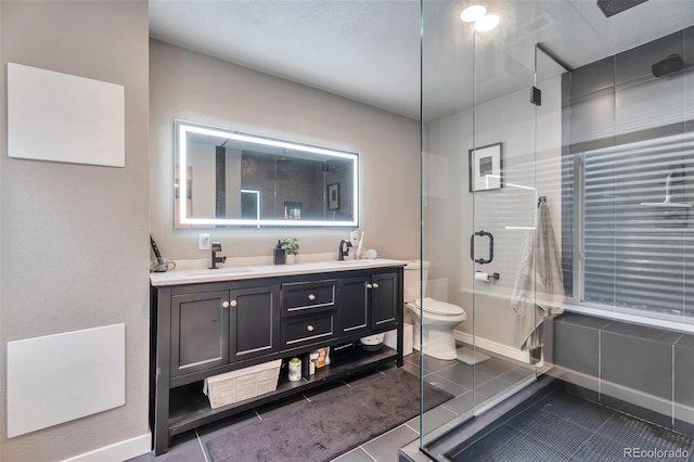 10695 Wynspire Rd, Highlands Ranch, CO 80130 - bathroom with a stall shower, double vanity, tile patterned flooring, toilet, and baseboards