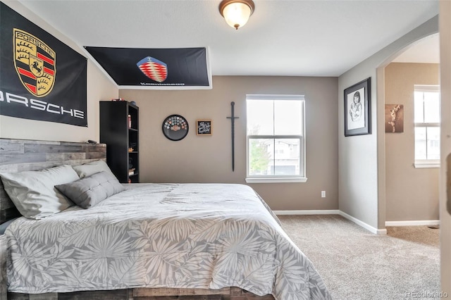 10695 Wynspire Rd, Highlands Ranch, CO 80130 - bedroom featuring carpet, multiple windows, arched walkways, and baseboards