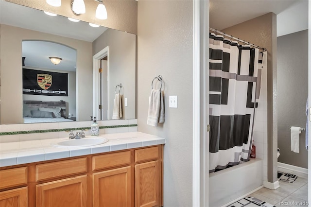 10695 Wynspire Rd, Highlands Ranch, CO 80130 - bathroom with vanity, tile patterned flooring, and shower / bath combo with shower curtain